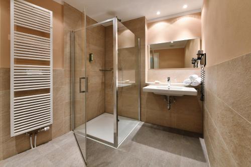 a bathroom with a shower and a sink at Hotel Rebenhof in Baden-Baden