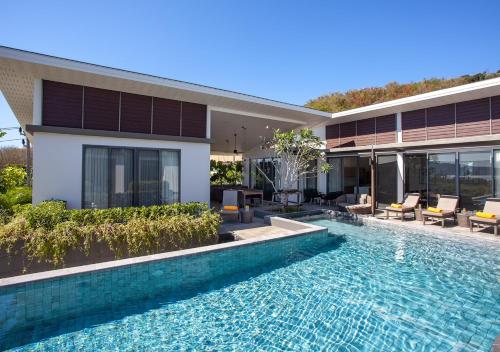 a house with a swimming pool in front of a house at CASABAY Luxury Pool Villas by STAY in Rawai Beach