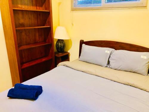 a bedroom with a bed with a blue towel on it at Thai Family karon Pool Villa 泰如家卡伦3卧泳池别墅 in Karon Beach
