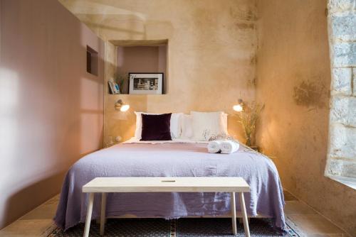 a bedroom with a bed and a table at La Maison des Sources in ‘Ayn Zḩaltā