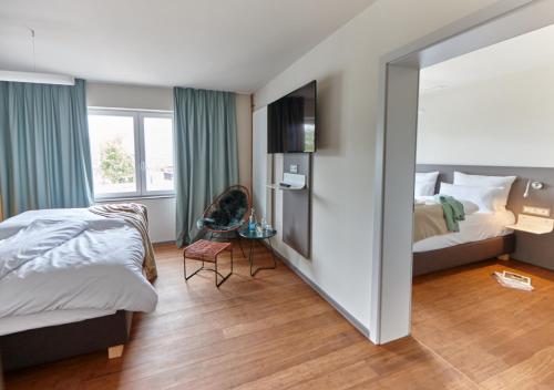 a hotel room with a bed and a mirror at Just Eleven in Sankt Peter-Ording