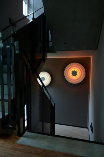 a staircase with two lights on a wall at Just Eleven in Sankt Peter-Ording