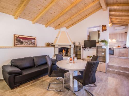 a living room with a table and a couch at Attractive Holiday Home with Pool bubble bath Patio Courtyard in Barbariga