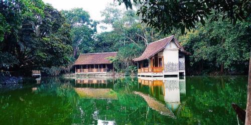 una casa en medio de un cuerpo de agua en Sapulidi Cafe, Gallery & Resort en Lembang