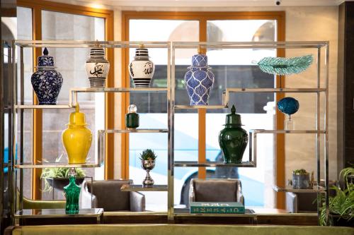 a display of vases on shelves in a window at Le Bosphorus Al Madinah in Medina