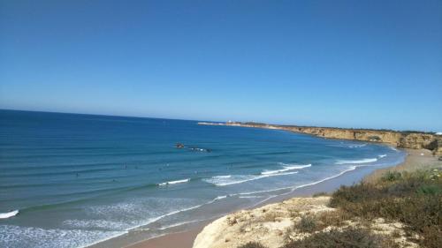 a view of a beach with people in the water at Aptº ATALAYA , cerca de la Playa in Conil de la Frontera