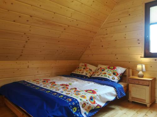 a bedroom with a bed in a log cabin at "U Kamińskich" in Przyborów