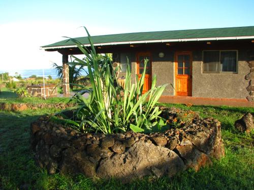 a rock garden in front of a house at Heva Eco Lodge in Hanga Roa