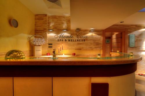 a bathroom with a sink and a sign on the wall at Monte Casa SPA & Wellness in Petrovac na Moru