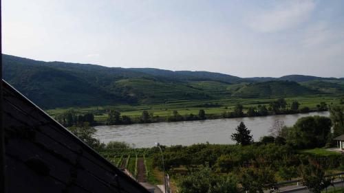 a view of a river with mountains in the background at Weingut & Gästezimmer Pammer in Mitterarnsdorf