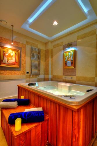a large bathroom with a tub in a room at Monte Casa SPA & Wellness in Petrovac na Moru