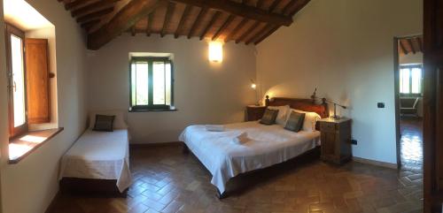 a bedroom with a large bed and a window at Villa Gaia in Seggiano