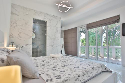 a bedroom with a bed and a marble wall at Hotel Paradise Road in Kutaisi