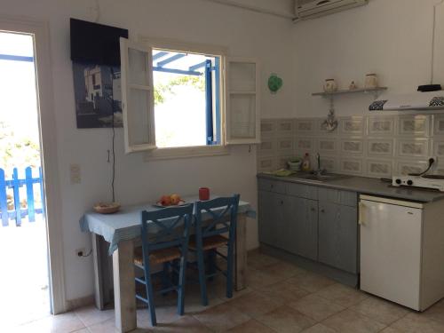a kitchen with a table and a counter top at Villa Costa Studios in Vathi, Sifnos