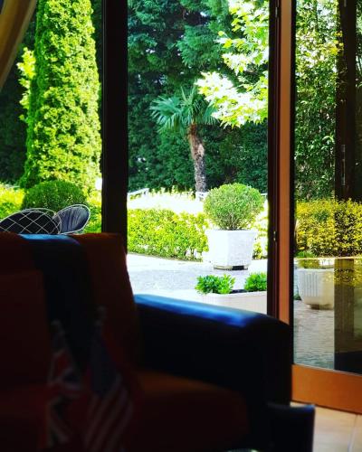 a room with a window looking out at a garden at Hotel Ambasador Garden in Lezhë