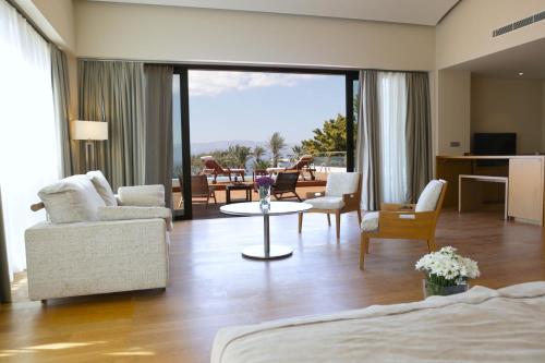 a living room with a bed and a table and chairs at ON'LIVE HOTEL in Cesme