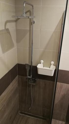 a shower with a shower head and a sink at Original Apartments in Albufeira