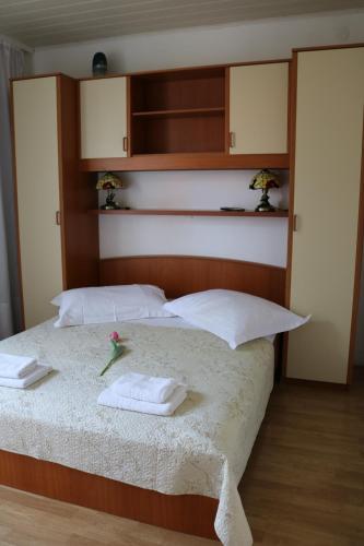 a bedroom with a bed with towels on it at Apartment Topic in Baška Voda