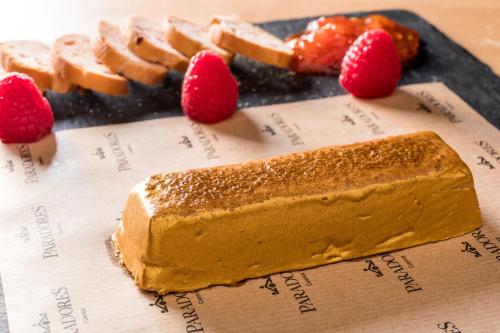 a piece of cake and raspberries on a table at Parador de Cuenca in Cuenca