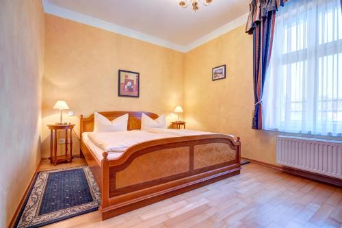 a bedroom with a bed and a large window at Seeschloß Heringsdorf - Villa aus Gründerzeiten in Heringsdorf