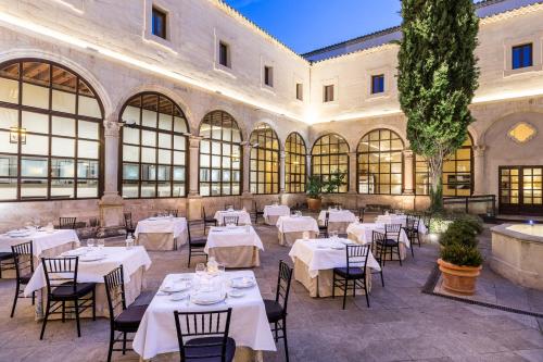 a restaurant with tables and chairs in a building at Parador de Cuenca in Cuenca