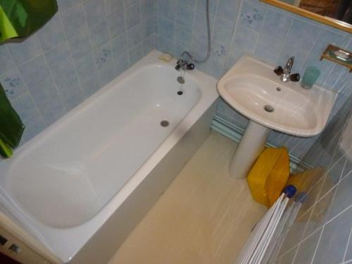 a bathroom with a sink and a bath tub and a sink at Bouffée d Oxygène in Le Seignus