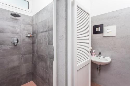 a bathroom with a sink and a shower at Hotel Giamaika in Cesenatico