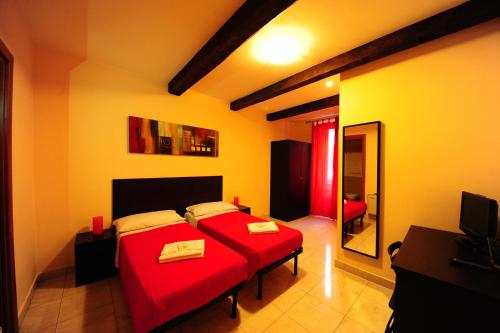 a bedroom with two beds and a television in it at Hotel Mosaic in Rome