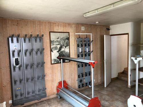 a gym with metal lockers and a wall at Hotel Le Soly in Morzine