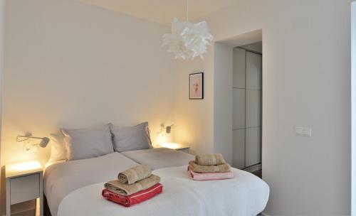 a bedroom with a white bed with towels on it at Wonderful City Apartment Av Salamanca by NRAS in Alicante