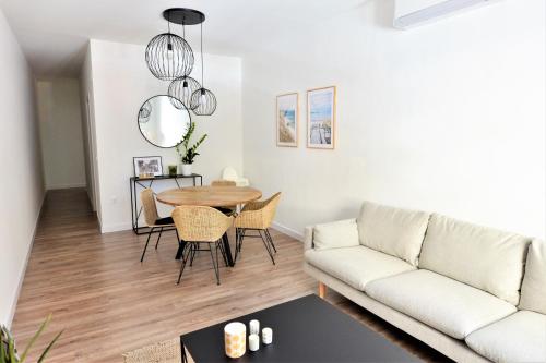 a living room with a couch and a table at Wonderful City Apartment Av Salamanca by NRAS in Alicante