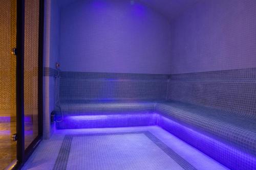 a purple room with a tub with purple lights at ON'LIVE HOTEL in Cesme