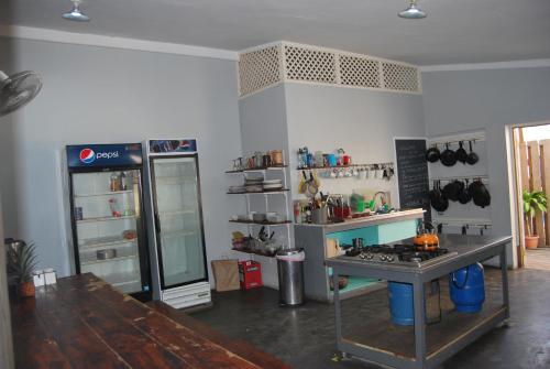 a kitchen with a refrigerator and a counter top at Mobay Kotch in Montego Bay