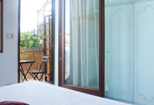 a bedroom with a bed and a sliding glass door at The Nest in Grosseto