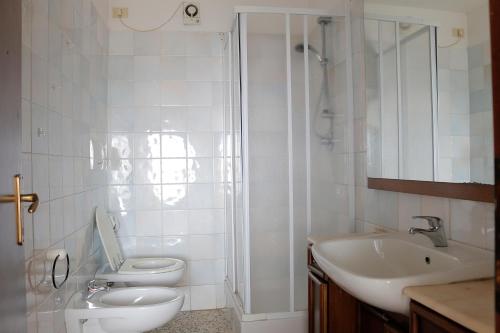 a bathroom with a toilet and a sink and a shower at The Nest in Grosseto