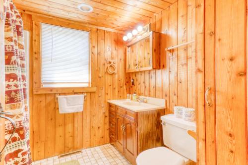 a wooden bathroom with a toilet and a sink at Twin View Log Home in Carroll