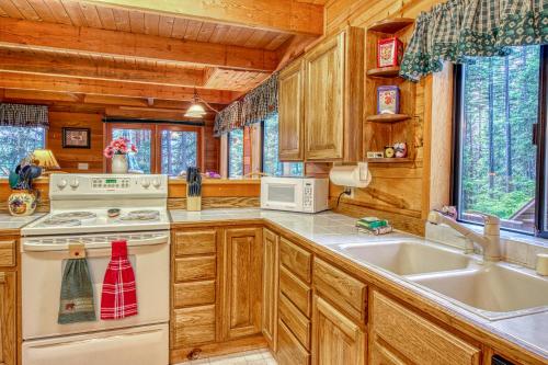 a kitchen with wooden cabinets and a stove and a sink at Keoni's Place in Leavenworth