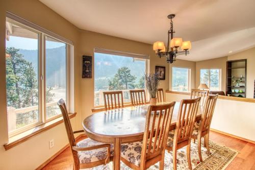 a dining room with a table and chairs and windows at The Hawks Nest in Manson