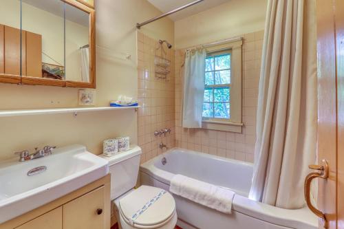 a bathroom with a tub and a toilet and a sink at Emmon's Mittersill Village Chalet in Franconia