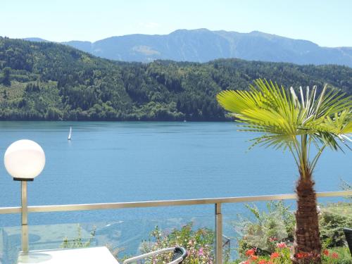 a view of a lake from a balcony at Pension Sedlak in Millstatt