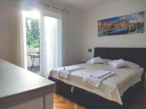 a bedroom with a bed with towels on it at Apartment LIM in Budva