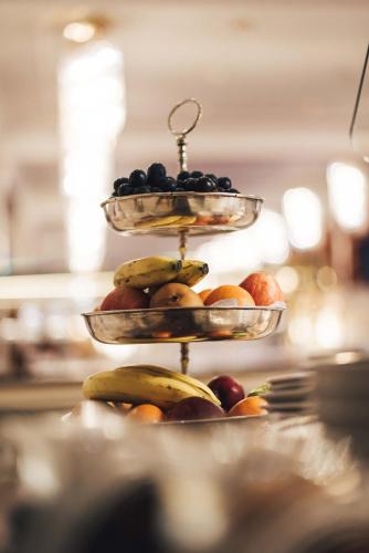 a three tiered display of fruit on a table at Palais Bad Ragaz in Bad Ragaz