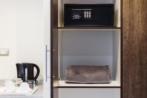 a microwave oven sitting on top of a shelf at Nobile Hotel Estación Central in Santiago