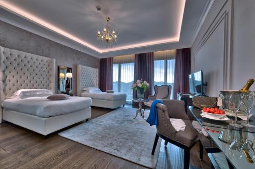 a bedroom with a bed and a living room at Hotel President Terme in Abano Terme