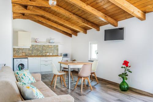 a living room with a couch and a table at Il Pozzo Incantato in Vico Equense