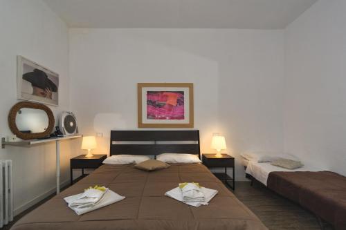 1 dormitorio con 1 cama grande y toallas. en Le Ciel d'Orphèe, en Pisa