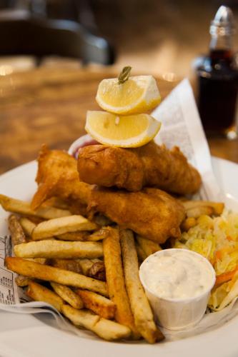 a plate of food with fried fish and french fries at The Georgetown Inn in Canmore
