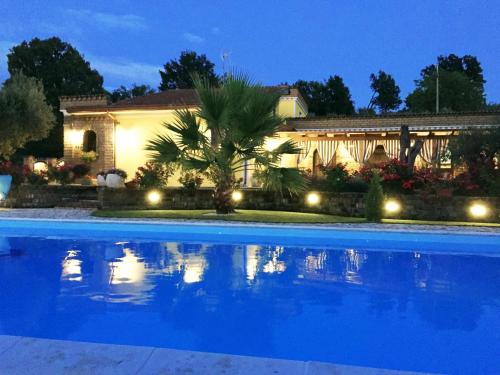 a house with a blue swimming pool at night at VILLA "Casa al Chiazzullo" in Mirabella Eclano