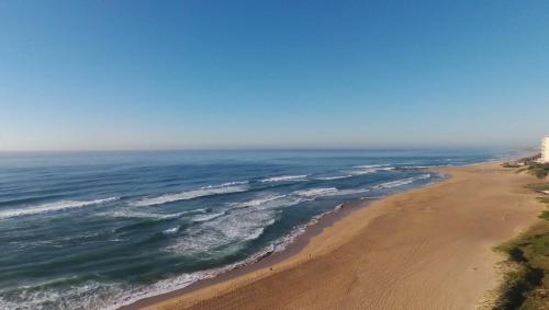 an aerial view of a beach with the ocean at 5 Key Largo in Amanzimtoti