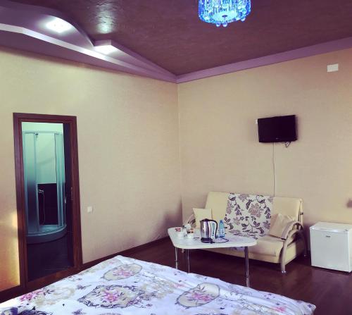 a bedroom with a bed and a table and a chair at Vale hotel&restaurant complex in Gyumri